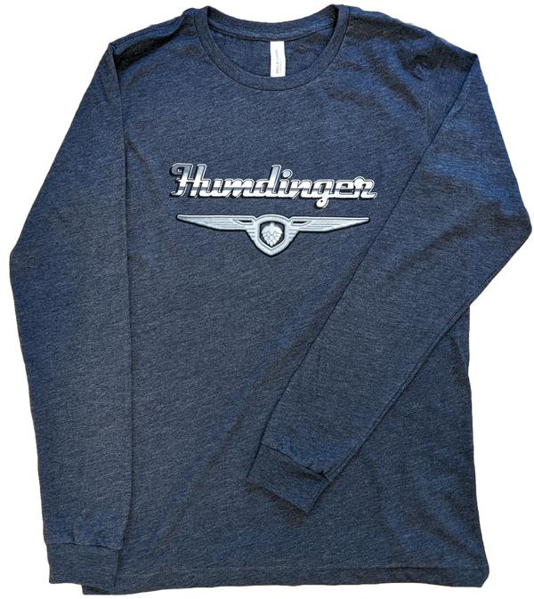 A folded, grey, long sleeve shirt with the Humdinger logo (in a chrome, vintage style) across the front of the shirt. This classic long-sleeve is made with super soft and cozy fabric. It's sure to become a new favourite! Unisex sizing, slim fit.