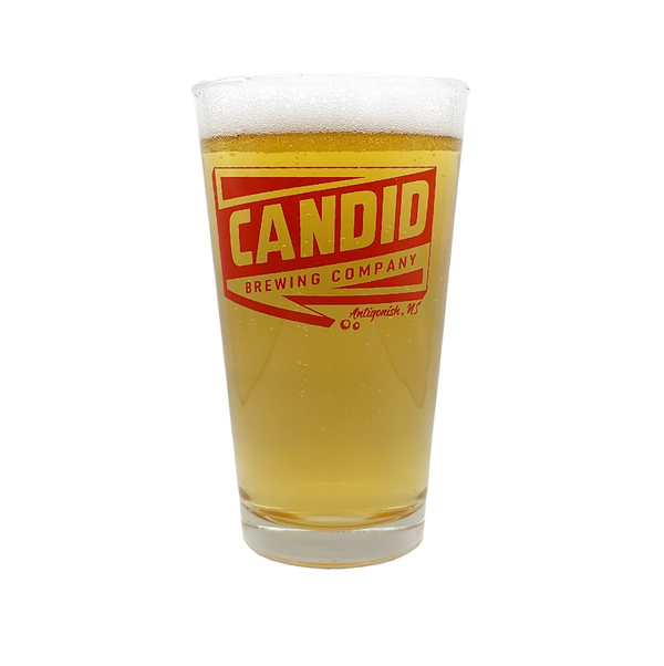 A pint of Candid's Kanpai Rice Lager in a Candid branded pint glass. 