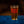 A Candid branded pint glass with beer in it. 