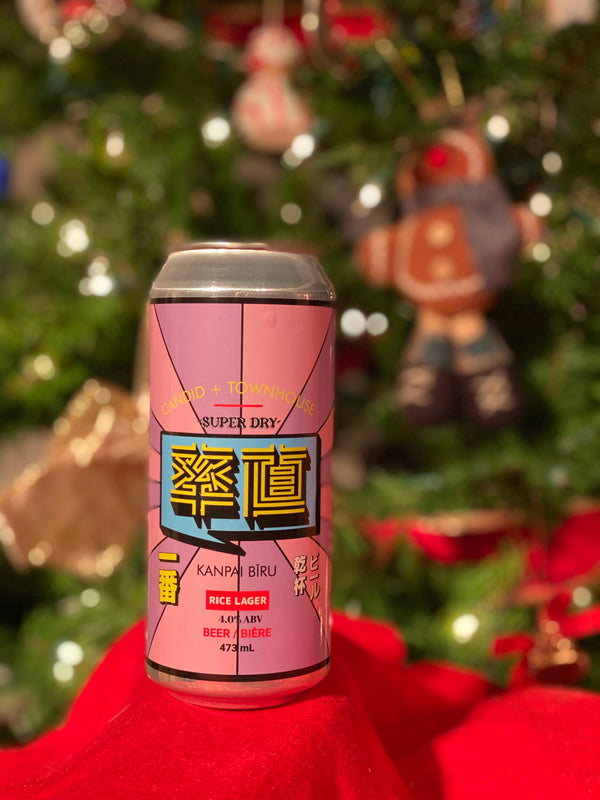 A can of Candid's Kanpai Rice Lager with a Christmas tree in the background.